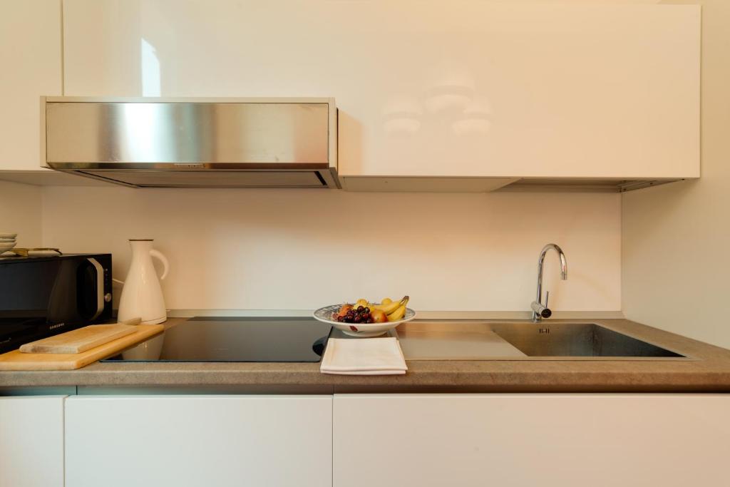 a kitchen with a sink and a bowl of fruit at Ca' Dorina Luxury in Venice