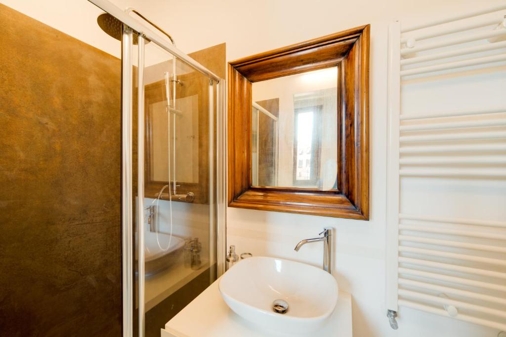 a bathroom with a sink and a shower and a mirror at Ca' Dorina Luxury in Venice