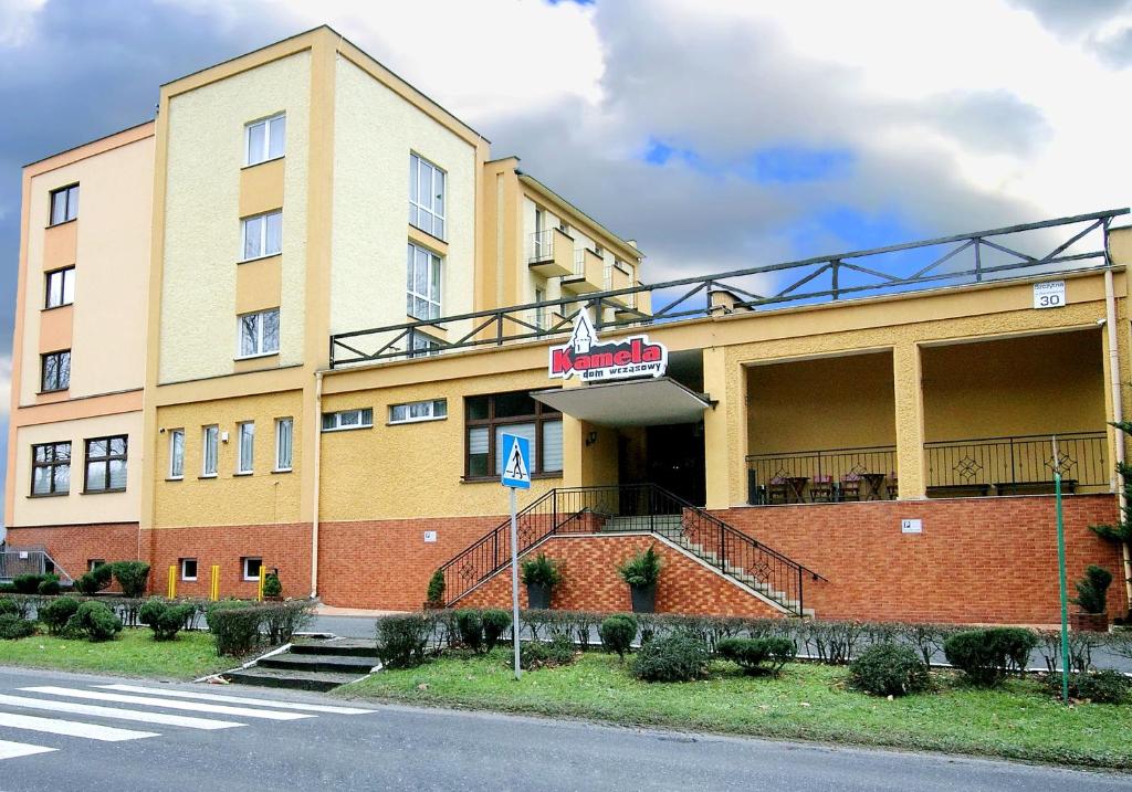 a large building with a staircase outside of it at Dom Wczasowy KAMELA in Szczytna