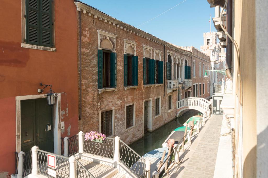 a view of a canal with buildings and a bridge at Ca' Dorina Luxury in Venice