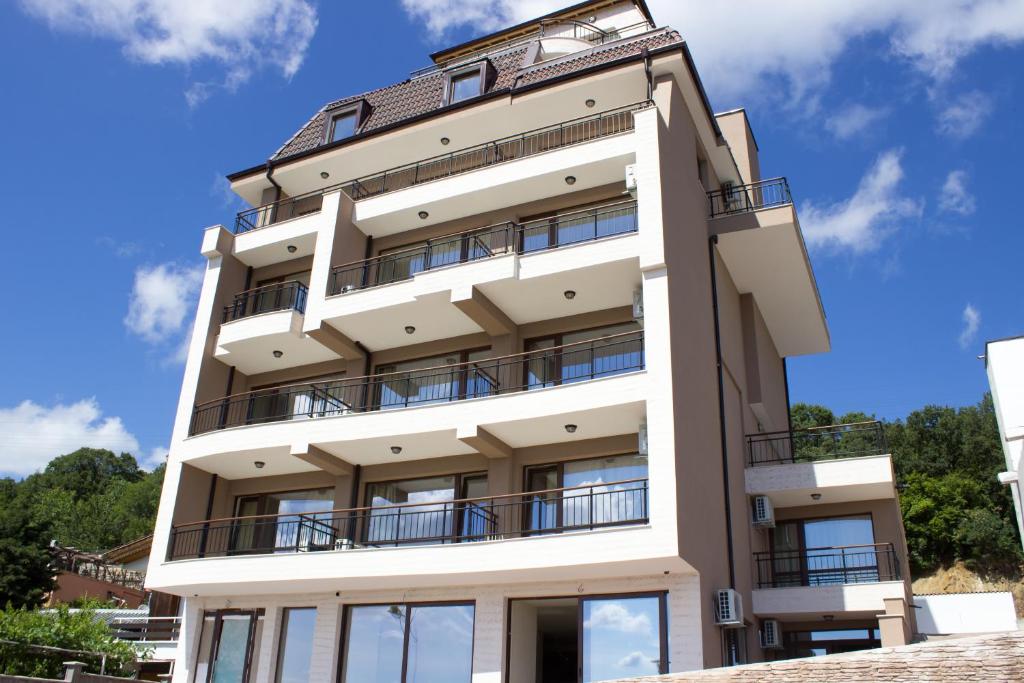 a building with balconies on the side of it at Sea View Hills in Sveti Vlas