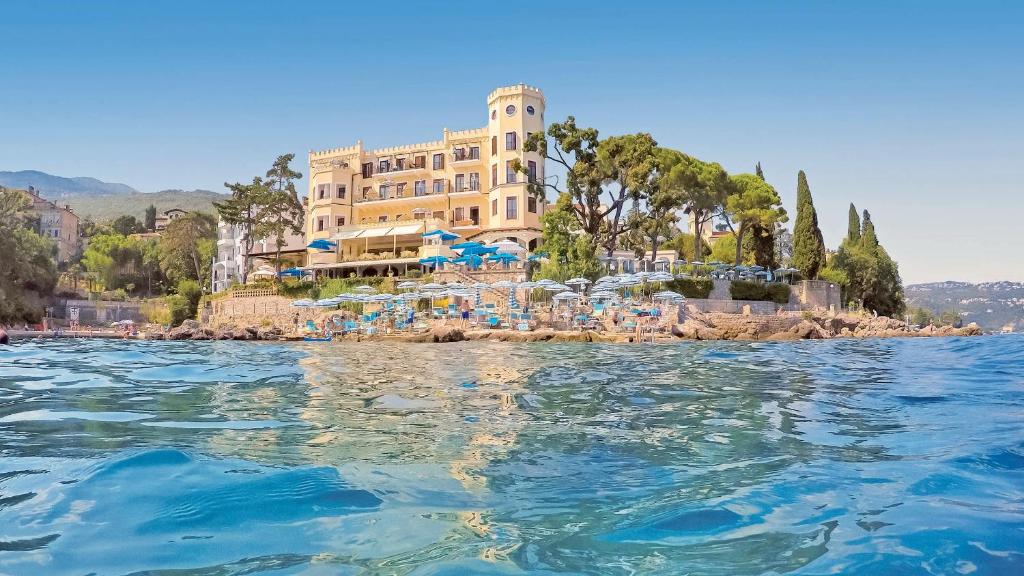 a hotel on the shore of a body of water at Hotel Miramar in Opatija