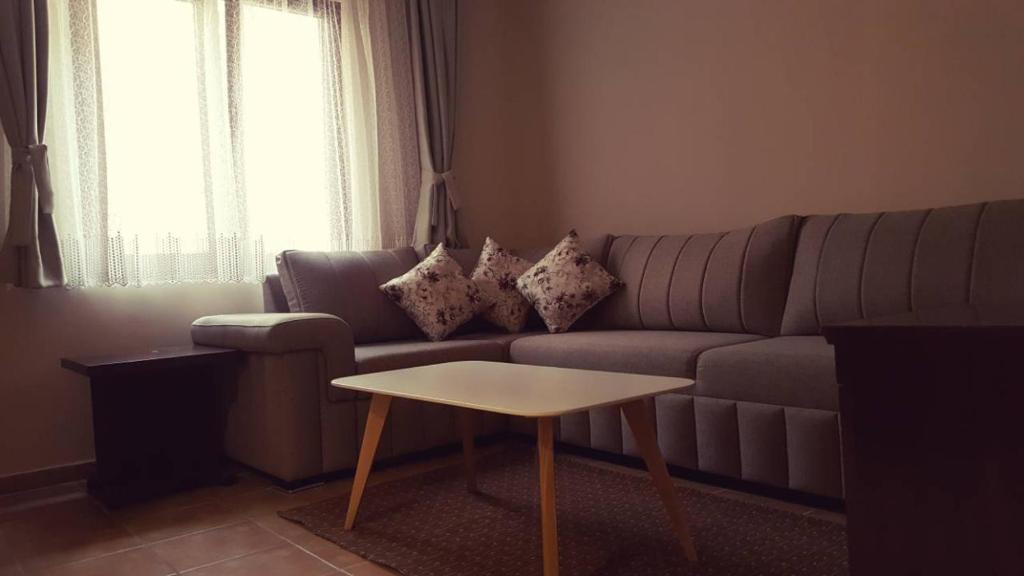 a living room with a couch and a table at Wellness & Spa Hotel ACD Annex in Herceg-Novi