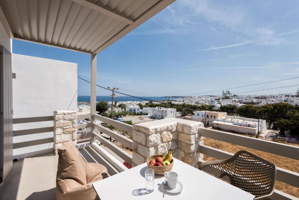 a table with a bowl of fruit on a balcony at Michael Zeppos Studios in Naousa