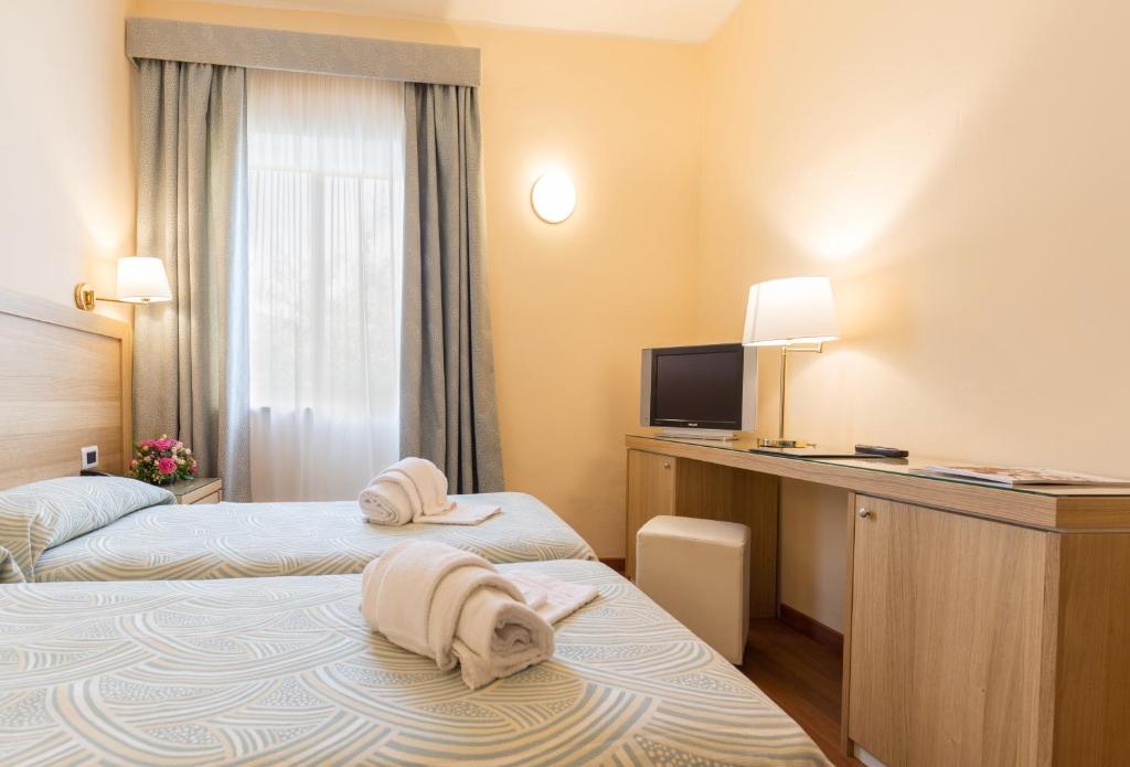 Postel nebo postele na pokoji v ubytování Hotel Villa Esperia