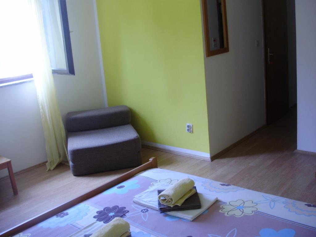 a living room with a table and a chair and a room at Villa Welcome in Vrboska