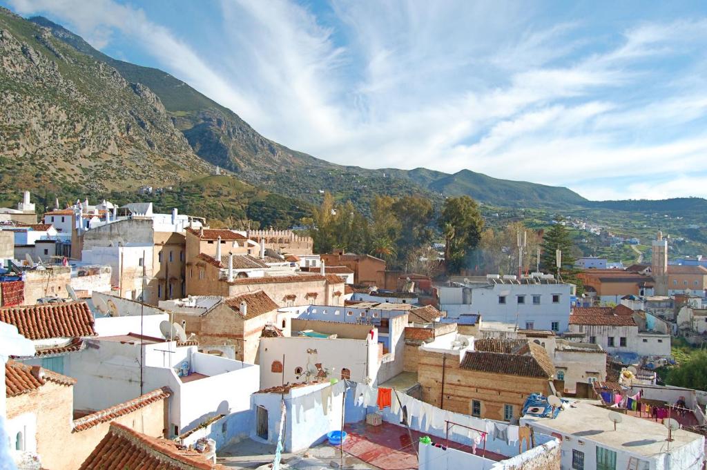a view of a village with mountains in the background at Casa Mablu in Chefchaouen