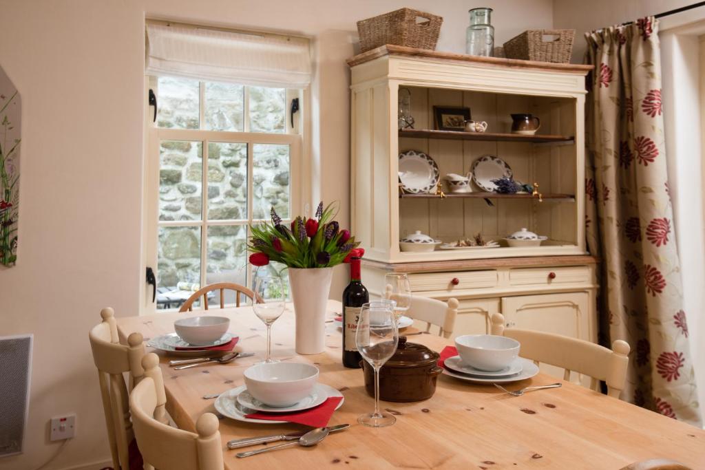 a dining room table with a bottle of wine at Heather Brae in Kelso