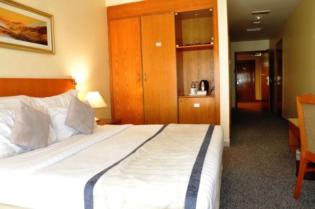Postel nebo postele na pokoji v ubytování Lavender Hotel Deira