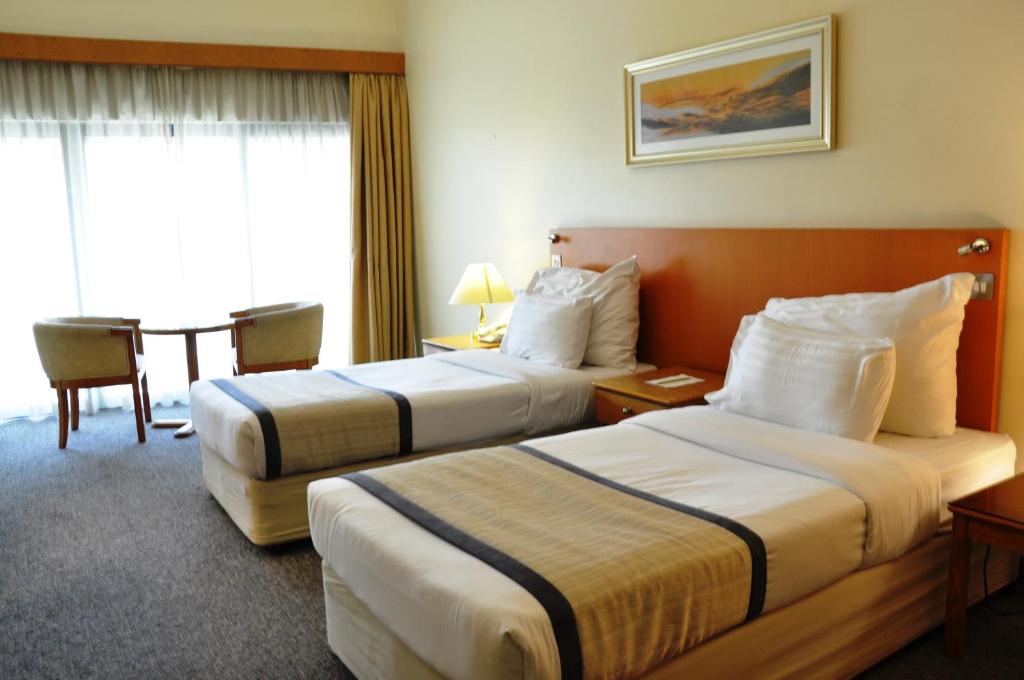Postel nebo postele na pokoji v ubytování Lavender Hotel Deira