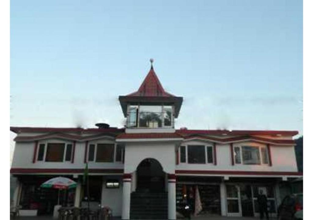 a building with a clock tower on top of it at Celebrations Homestay in Shimla