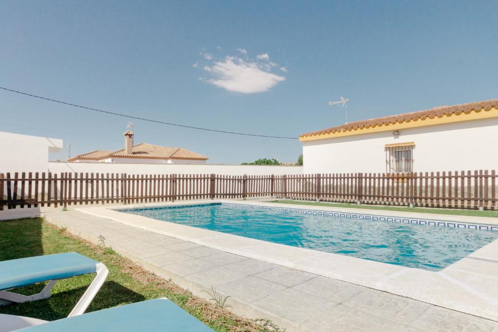 a swimming pool in front of a house at Casa Mariana in Conil de la Frontera