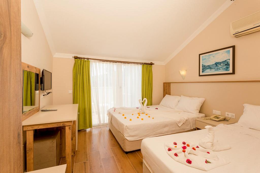 A bed or beds in a room at Rich Melissa Hotel