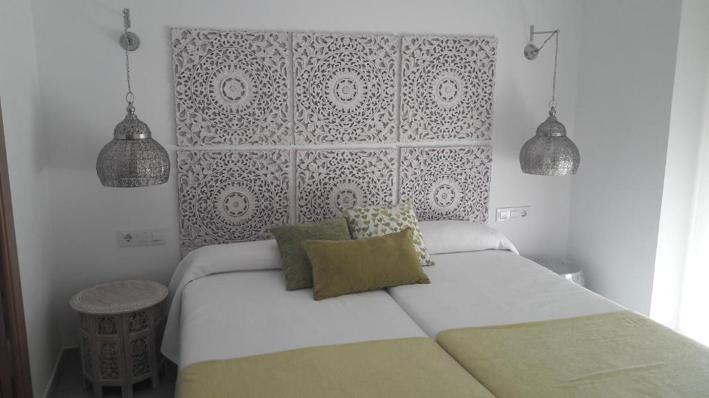 Postel nebo postele na pokoji v ubytování Hostal Cervantes Playa