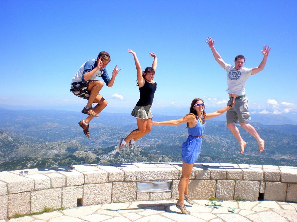 a group of people jumping off of a ledge at Montenegro Backpackers Home Budva in Budva