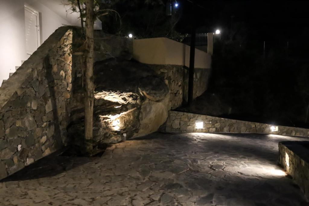 a stone staircase at night with lights at Skouros Villa in Kastrí