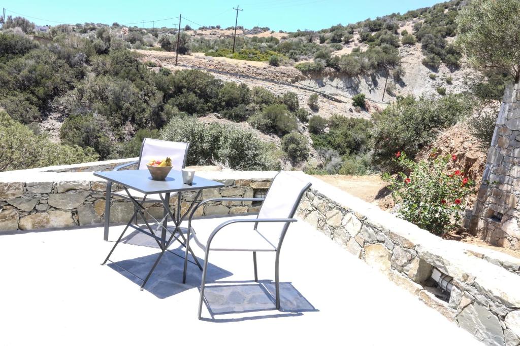 a table and chair on the balcony of a house at Skouros Villa in Kastrí