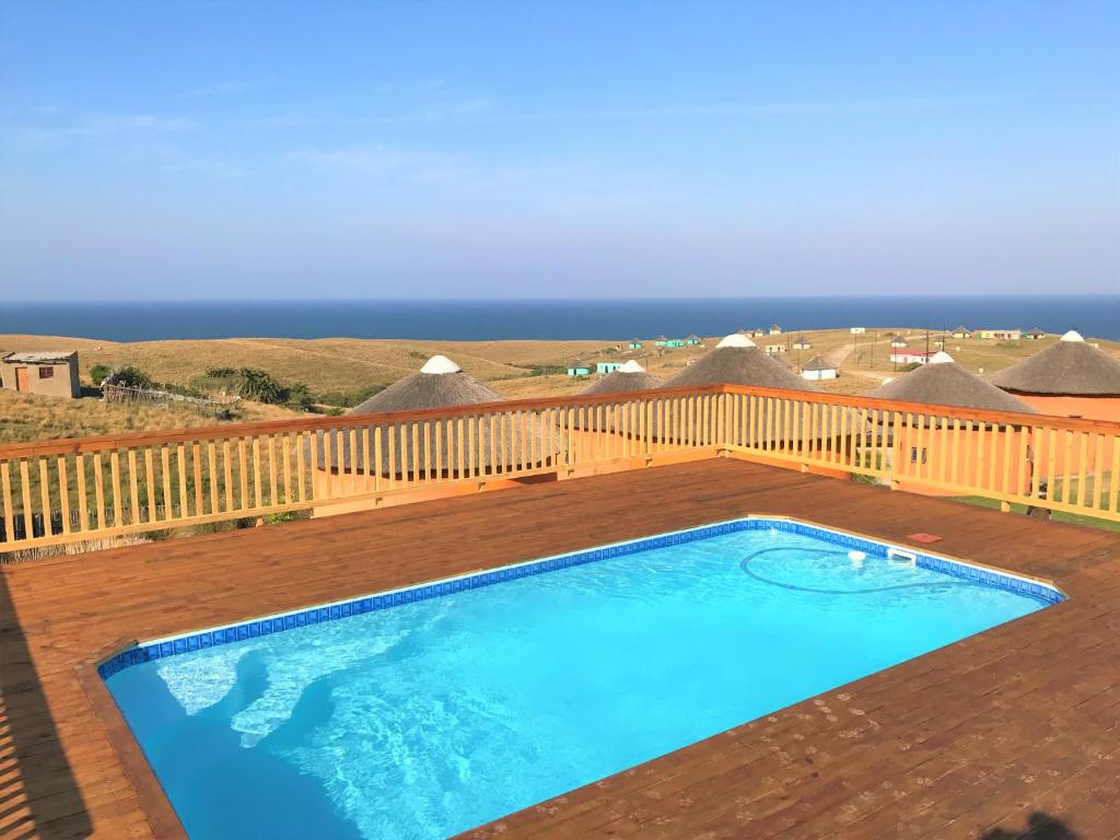 a swimming pool on top of a wooden deck at Swell Eco Lodge in Mdumbi