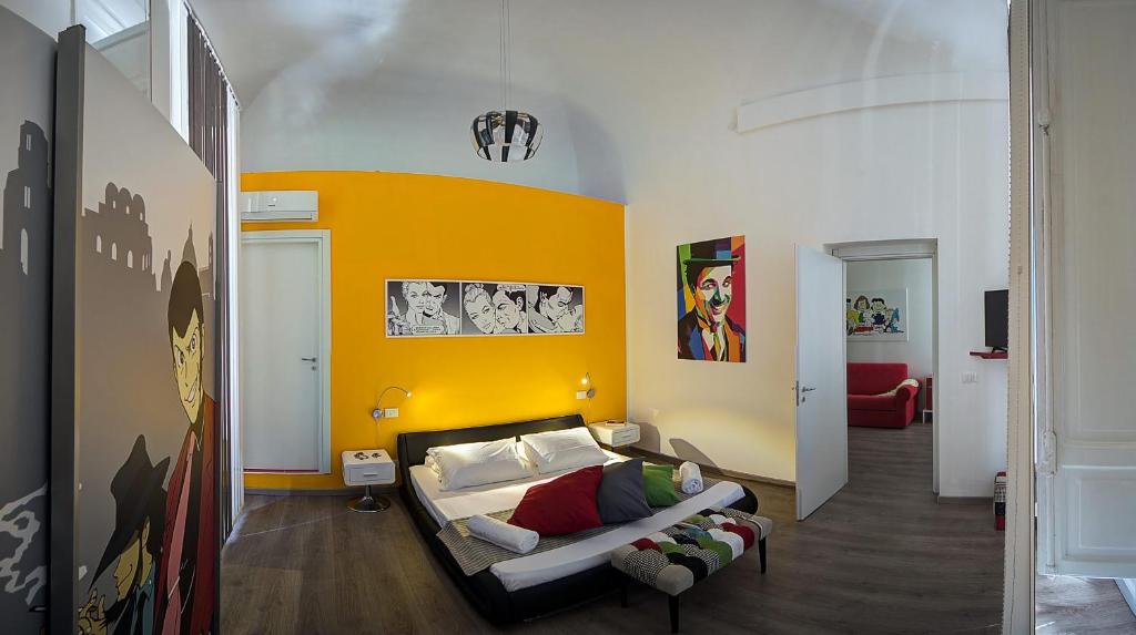 a living room with a couch and a yellow wall at Palermo Gallery in Palermo