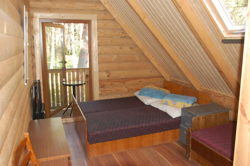 a room with a bed and a window in a cabin at Edmundas in Palanga