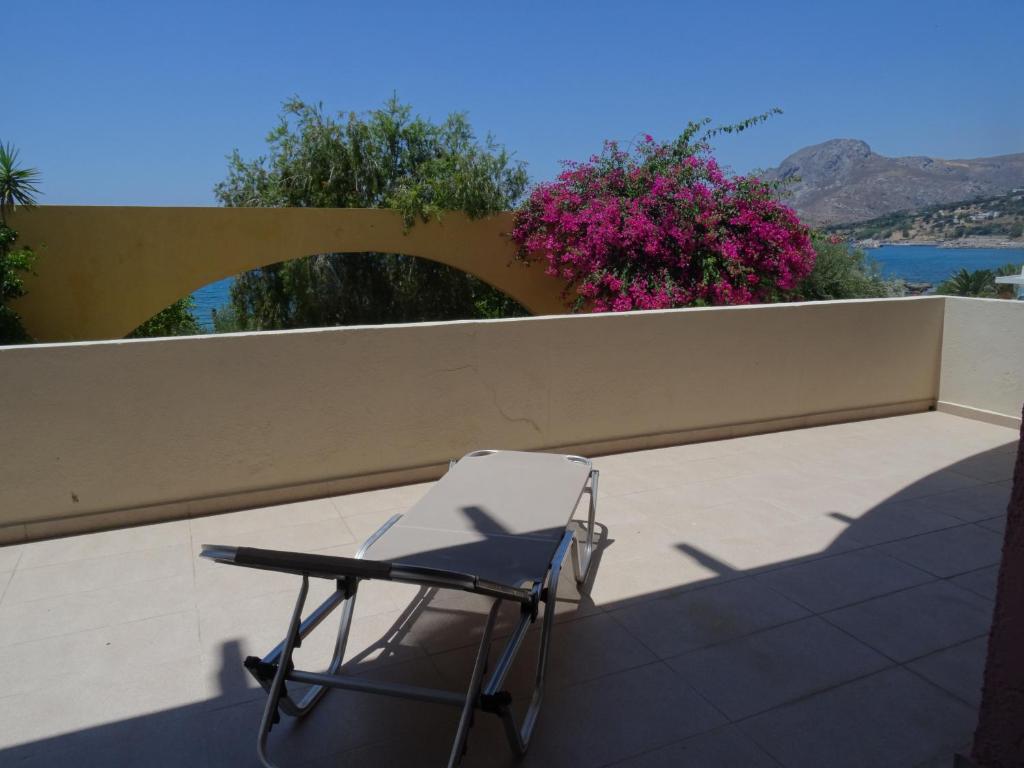 a chair sitting on top of a balcony at Horizon Beach Hotel in Plakias