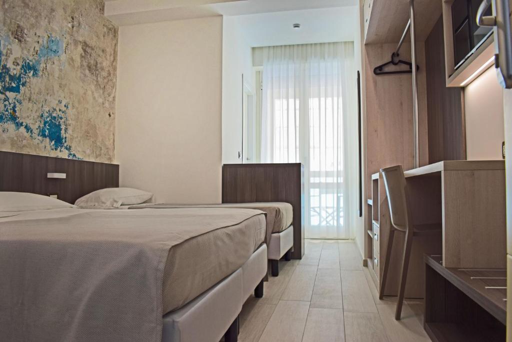 Postel nebo postele na pokoji v ubytování Hotel Muccioli