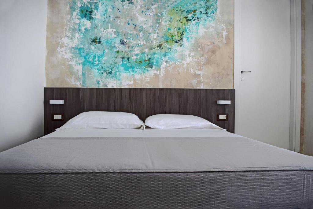 Postel nebo postele na pokoji v ubytování Hotel Muccioli