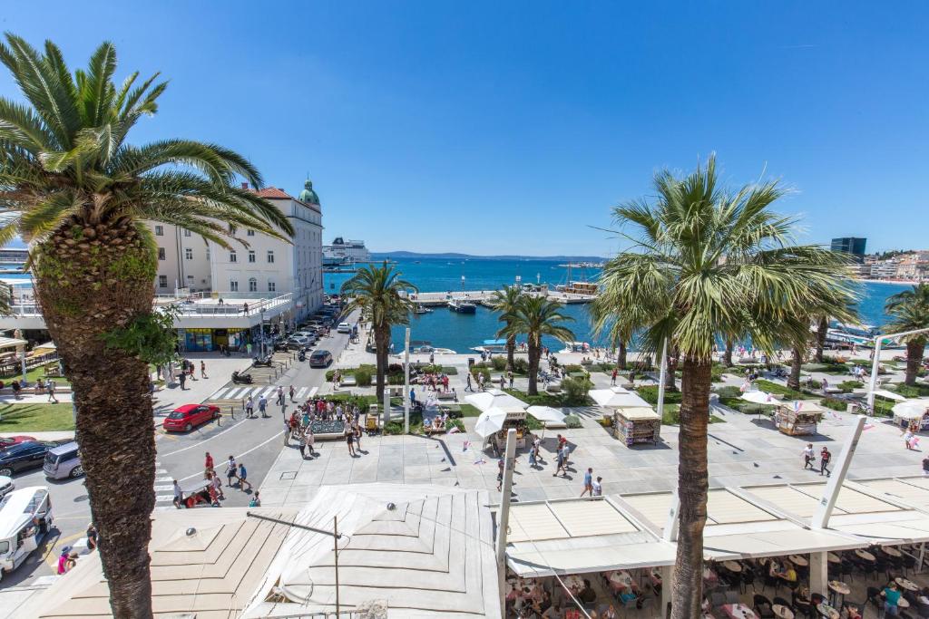 a view of a city with palm trees and the ocean at Riva Palace in Split