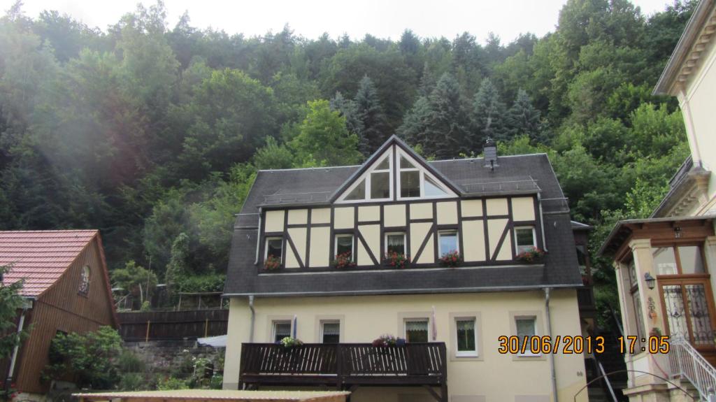 a white house with a black roof at Fewo Jahn in Bad Schandau