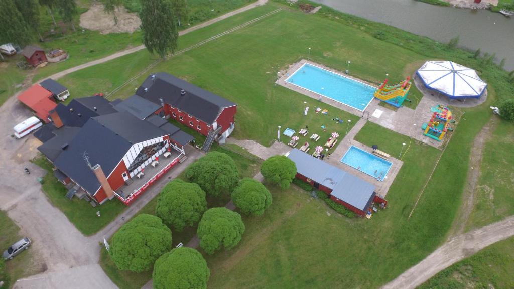 an aerial view of a house with a pool and a playground at Bollegården B&B in Bollnäs