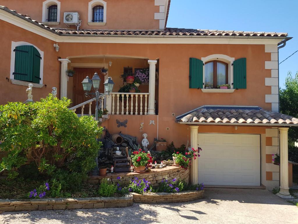 a man standing in the doorway of a house at Casa das Oliveiras in Flassans-sur-Issole