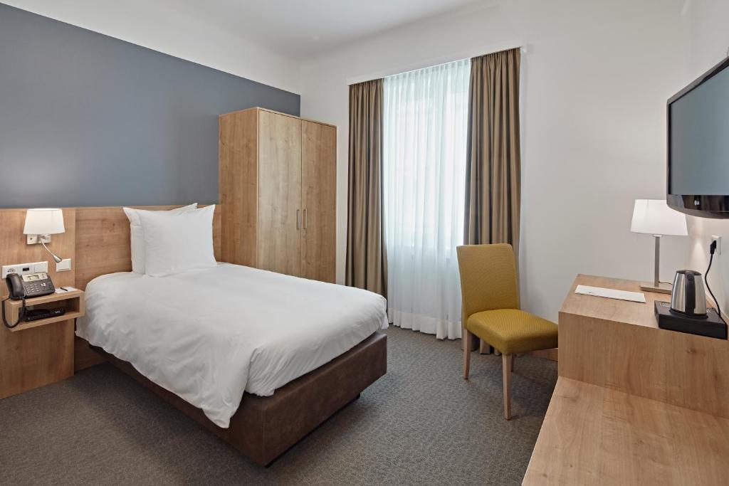Postel nebo postele na pokoji v ubytování City Hotel