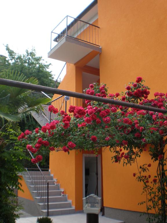 a building with red flowers on the side of it at SAN MARKO 2 in Lovran
