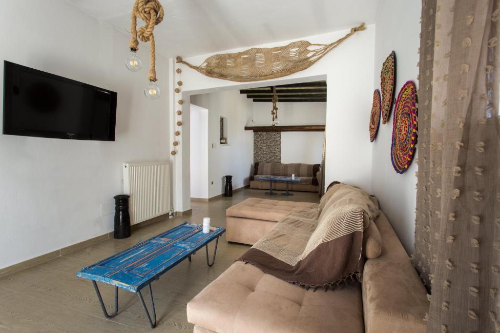a living room with a couch and a table at Paros Central house in Parikia