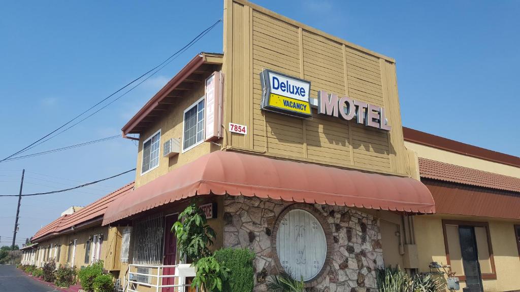 a building with a motel sign on the side of it at Deluxe Motel, Los Angeles Area in Downey
