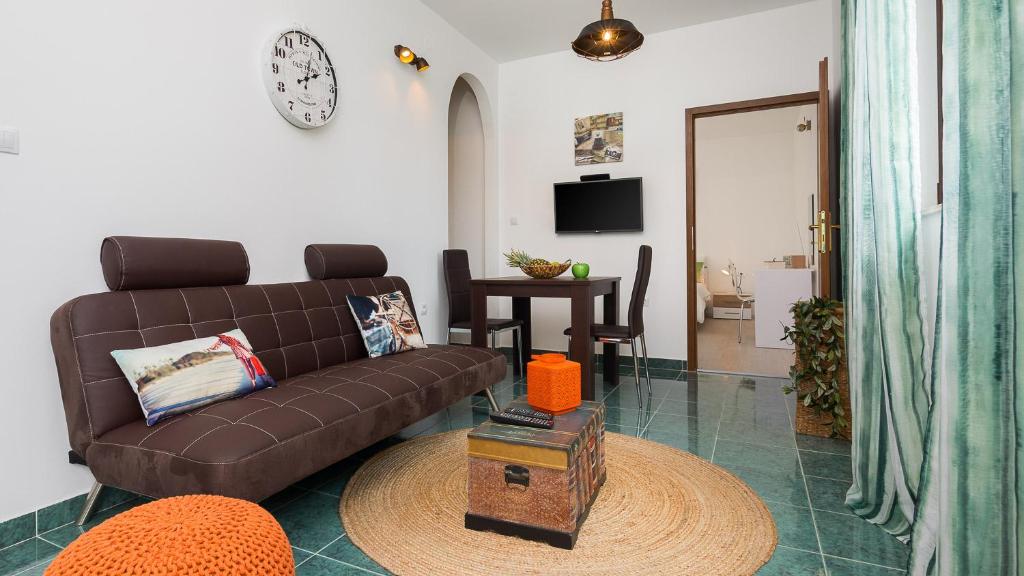 a living room with a brown couch and a table at "NM" Luxury apartments in Split