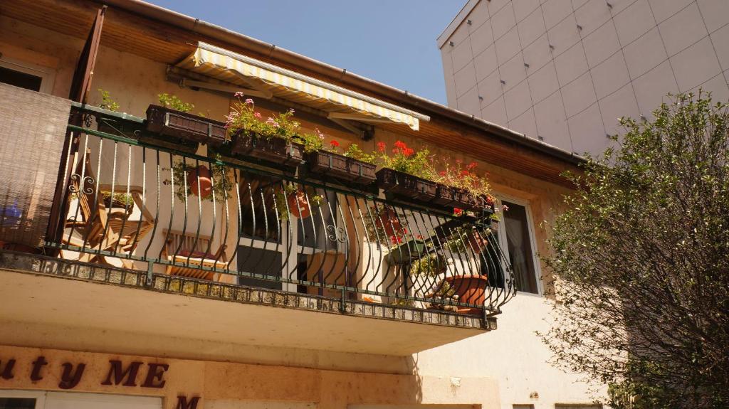 a balcony with potted plants on a building at Pláza Home in Siófok
