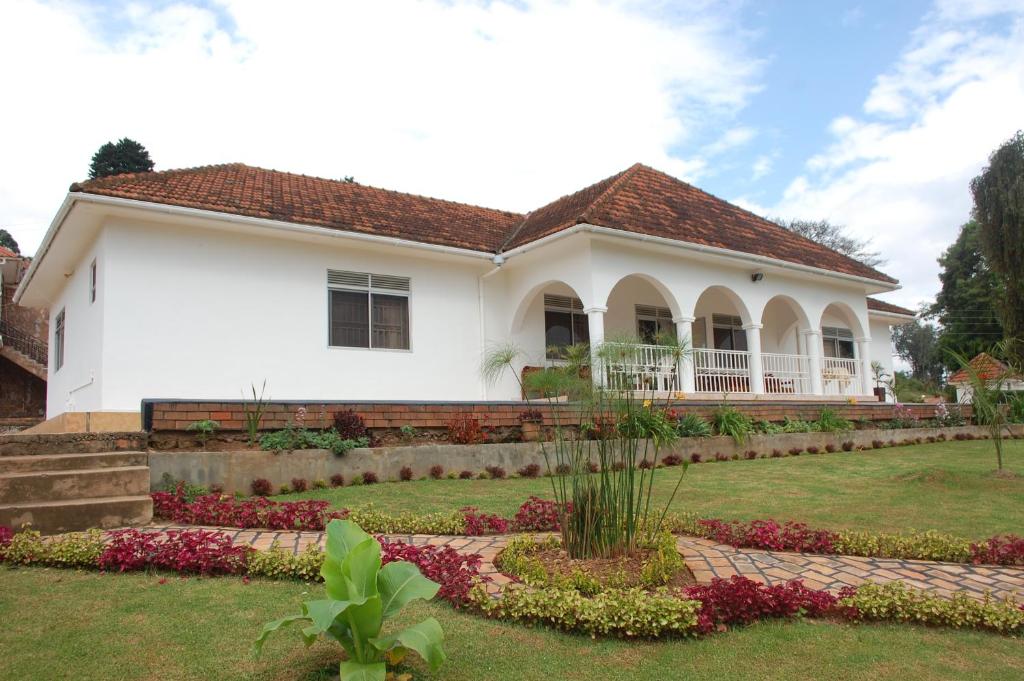 a house with a garden in front of it at Kigezi Gardens Inn in Kabale