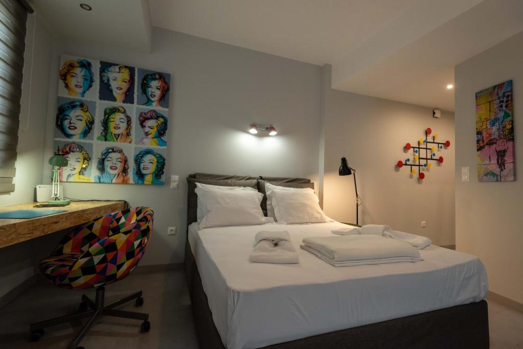 a bedroom with a bed with a desk and a chair at Acropolis Monastiraki Newly Renovated Apartment in Athens