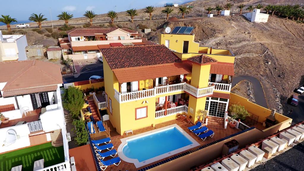 an aerial view of a house with a swimming pool at Hotel La Colina in Morro del Jable