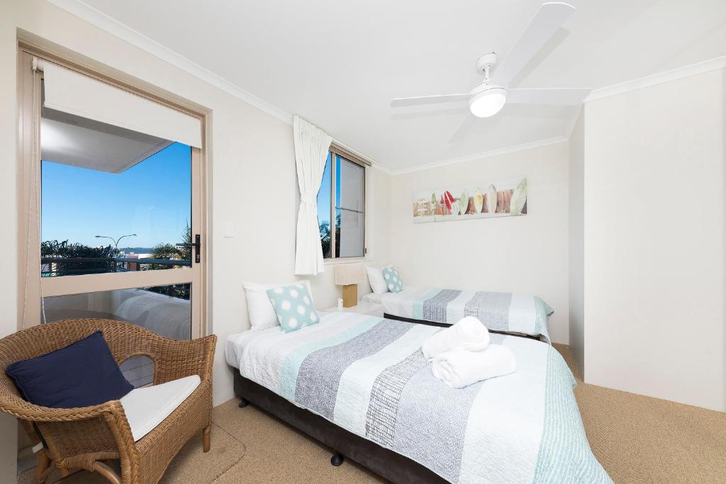 a bedroom with a bed and a desk at Beaches International in Forster