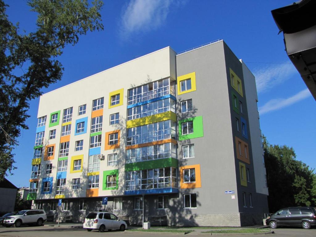 a building with colorful windows on the side of it at Max House in Barnaul