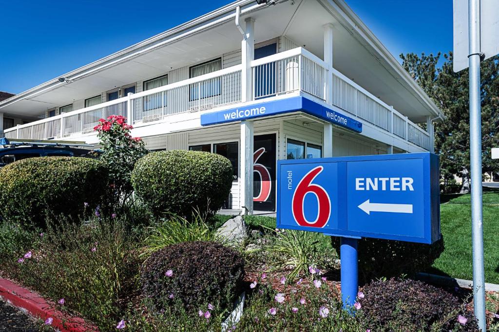 a house with a sign in front of it at Motel 6-Sparks, NV - Airport - Sparks in Reno