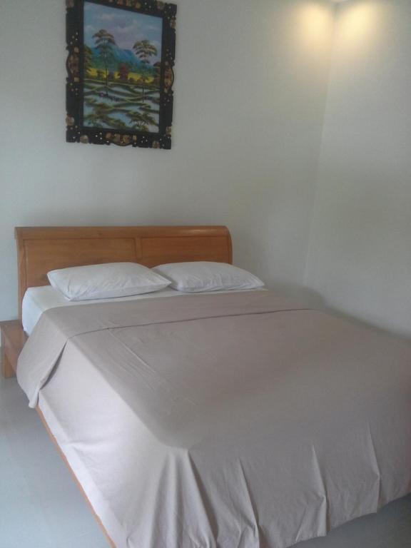 Postel nebo postele na pokoji v ubytování dewi ayu accomodation