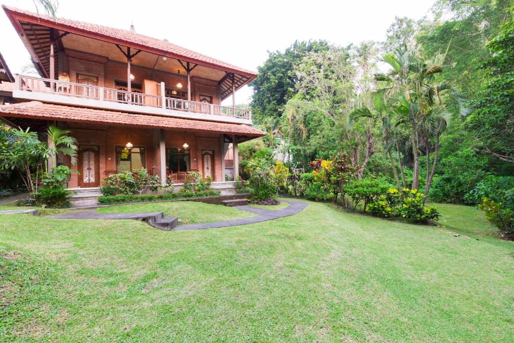 a house with a large yard in front of it at Wenara Bali Bungalows in Ubud