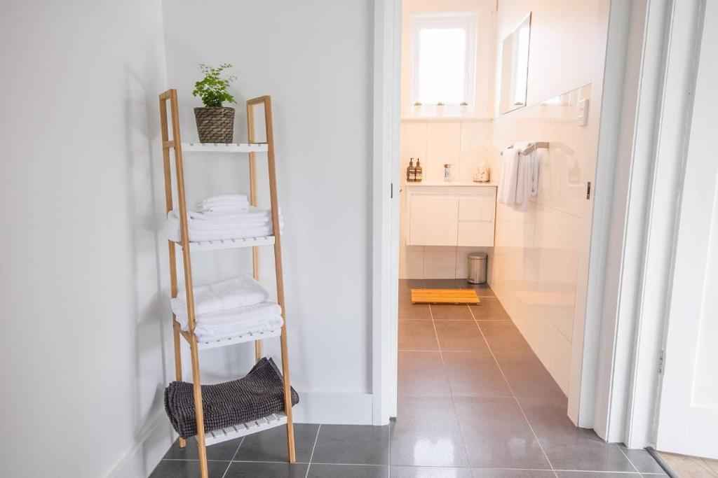 a bathroom with a ladder with towels on it at 49 Pedder in New Town