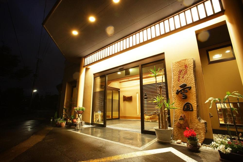 a building with plants in front of it at night at Hot spring inn Snow country(yukiguni) in Tsunan