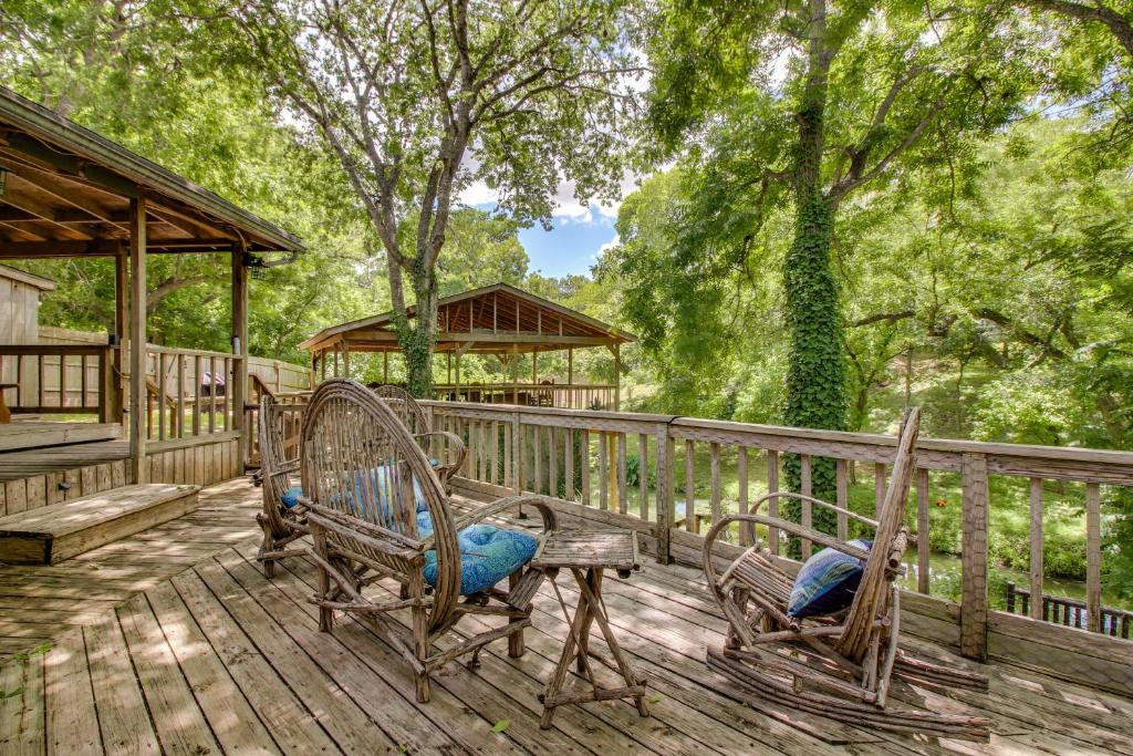 a deck with two benches and a gazebo at Creekside Casita in Schumannsville