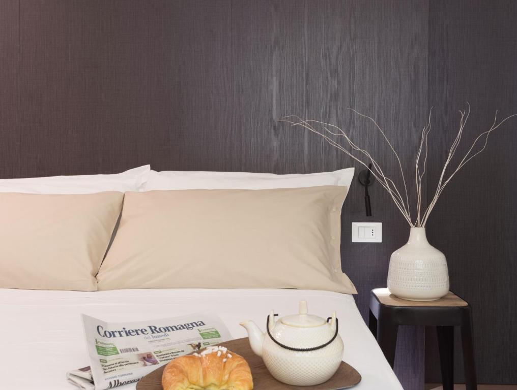 En eller flere senge i et værelse på Hotel Villa Tosi