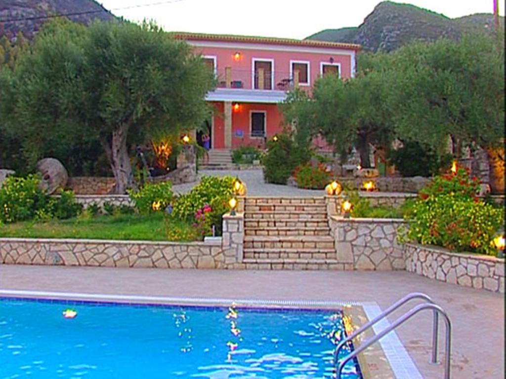 ein Haus mit einem Pool vor einem Haus in der Unterkunft Anatoli Labreon in Agia Marina